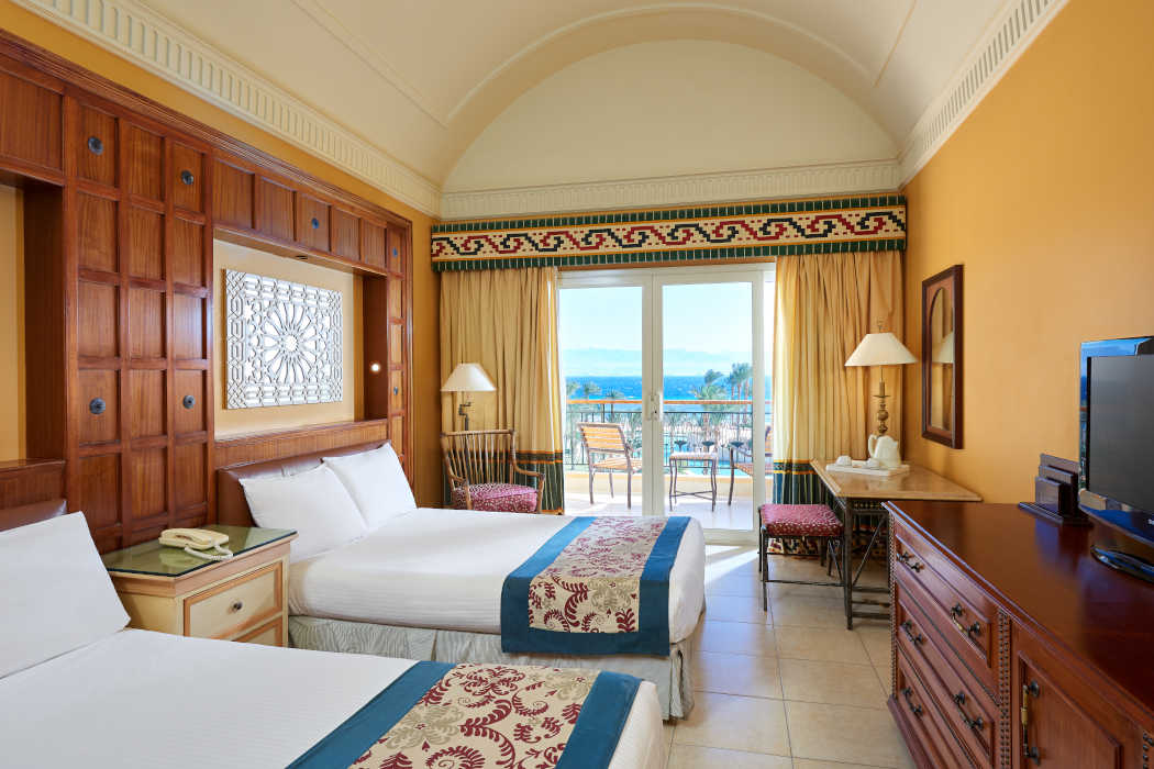 The overview of the twin bedding room at Mosaique Beach Resort and a balcony with Red Sea view