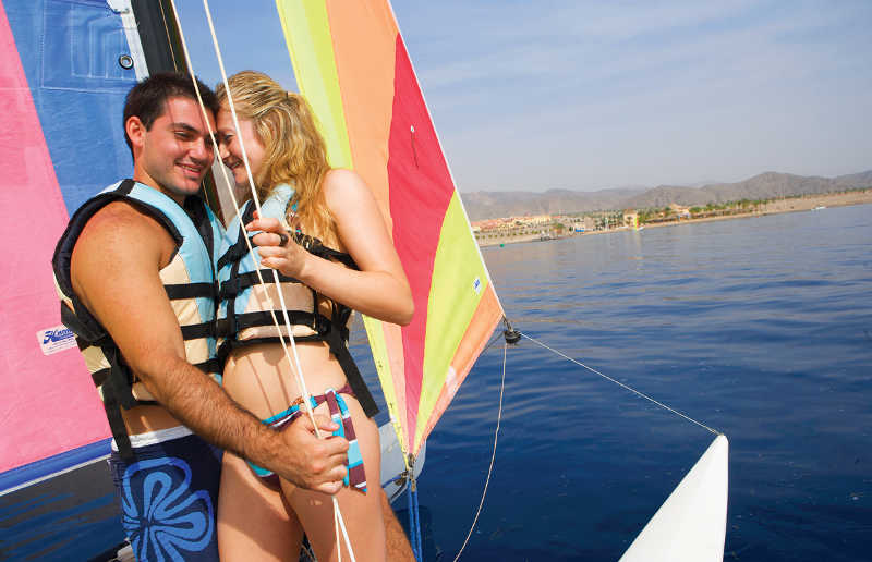 A couple enjoys the sailing as a watersport activity in Taba Heights Egypt