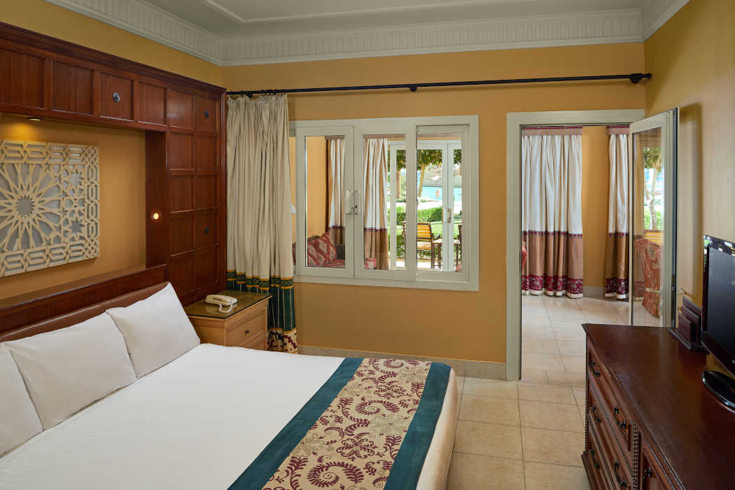 The family Suite at Mosaique Beach Resort with a kingbed room and a seating area connected with a door