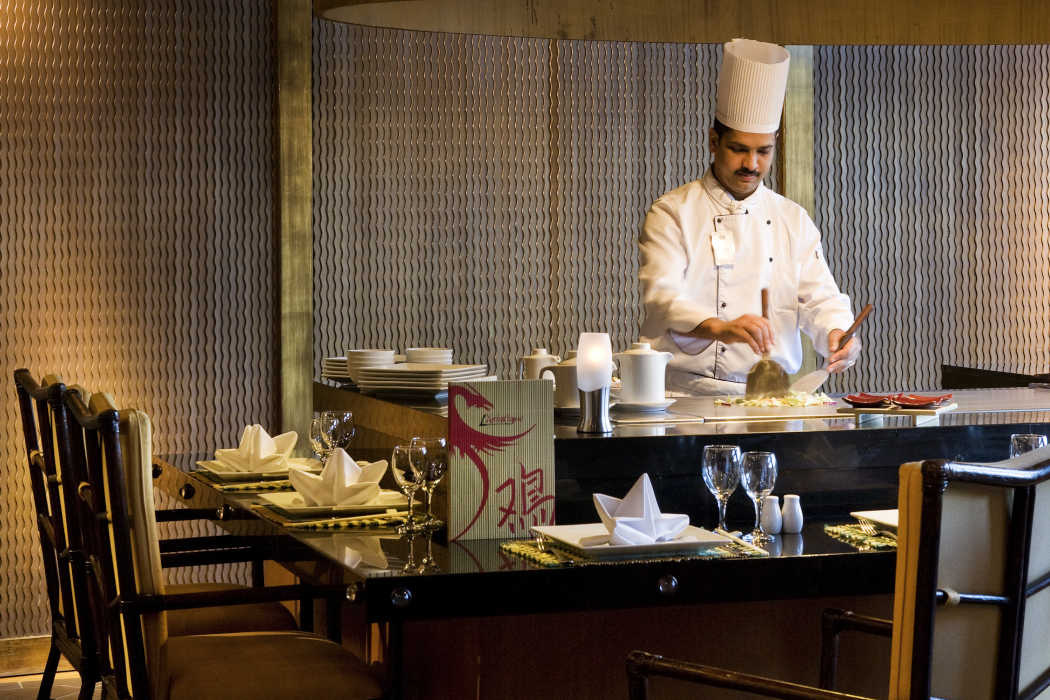 A chef at L'Asiatique Restaurant Asian Cuisine prepares fresh food to guests