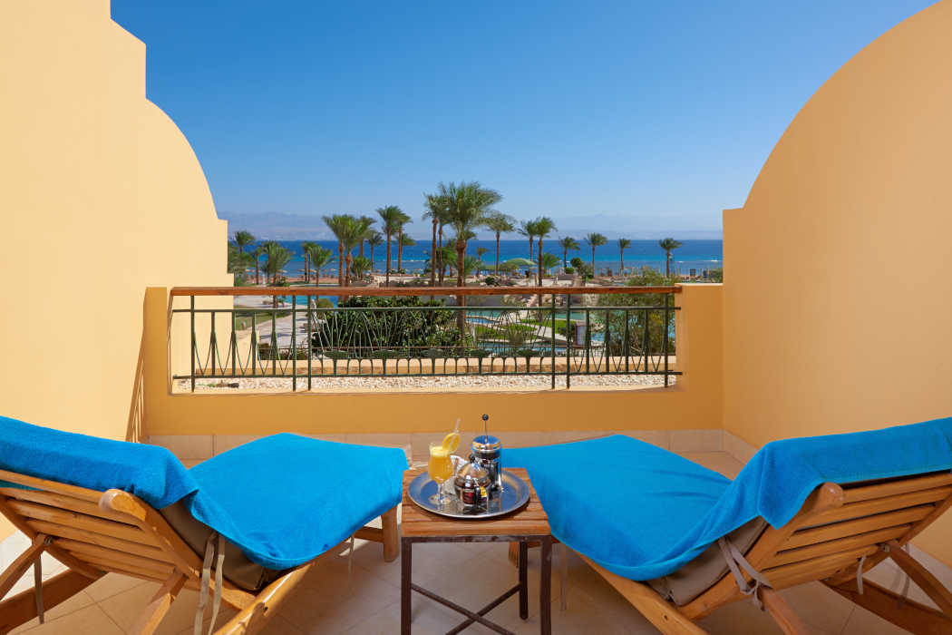 2 sunbeds at the room's balcony at Mosaique Beach Resort with the view of Red Sea
